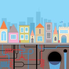 A drawing of houses in a city with water pipes and sewers underground