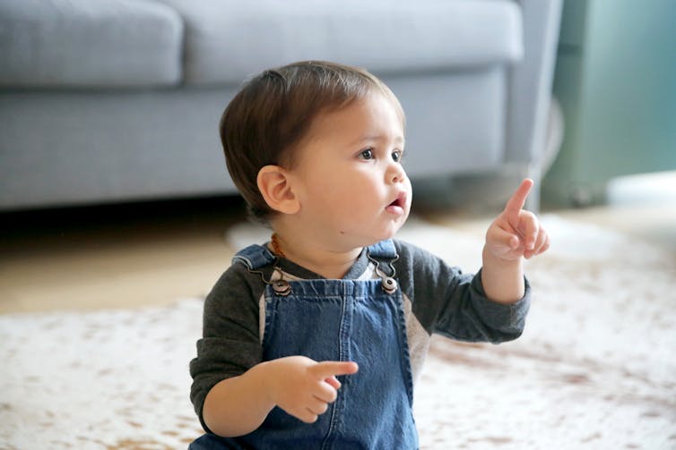 A child raises a finger