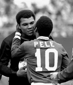 Two men embrace.