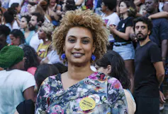 A woman smiles for the camera.