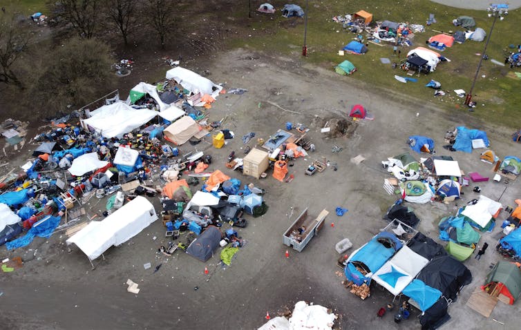 Aerial photograph of a car park with tents and personal belongings
