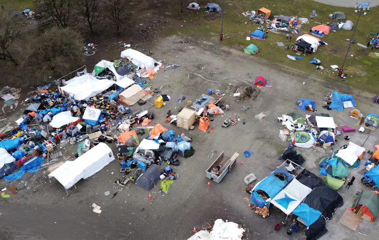 Aerial photograph of a car park with tents and personal belongings