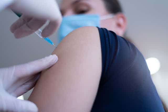 A vaccine is injected into a person's arm.