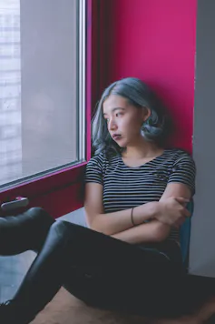 Woman alone looking out a window