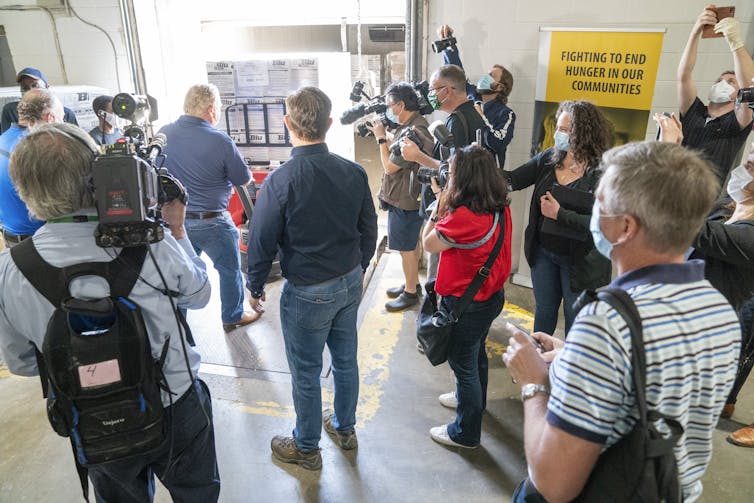 journalists filming and watching