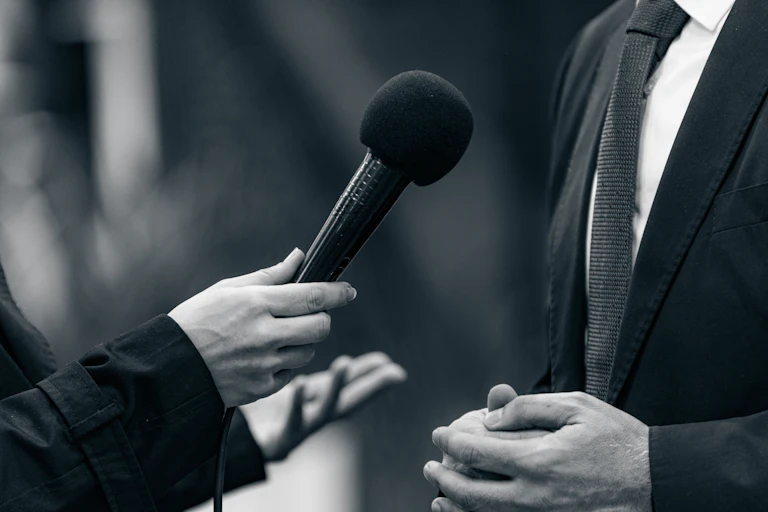 A microphone is held for an interview