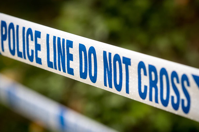 Police tape stating: 'do not cross'.