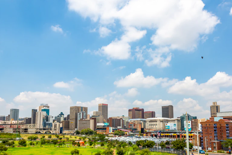 Johannesburg cityscape with its buildings and green spaces.