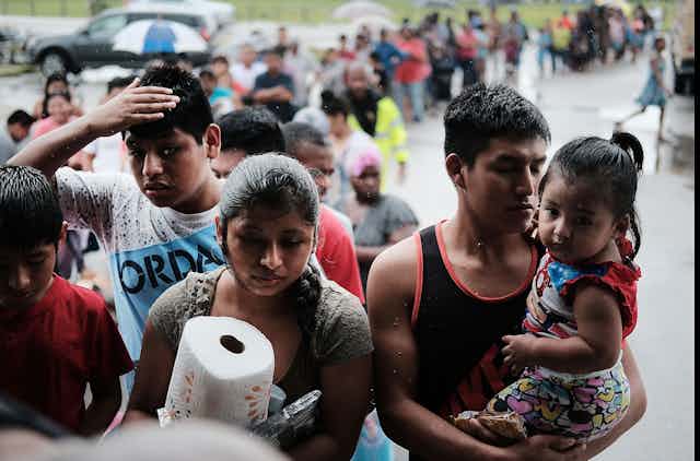 Migrants receive paper towels and other supplies