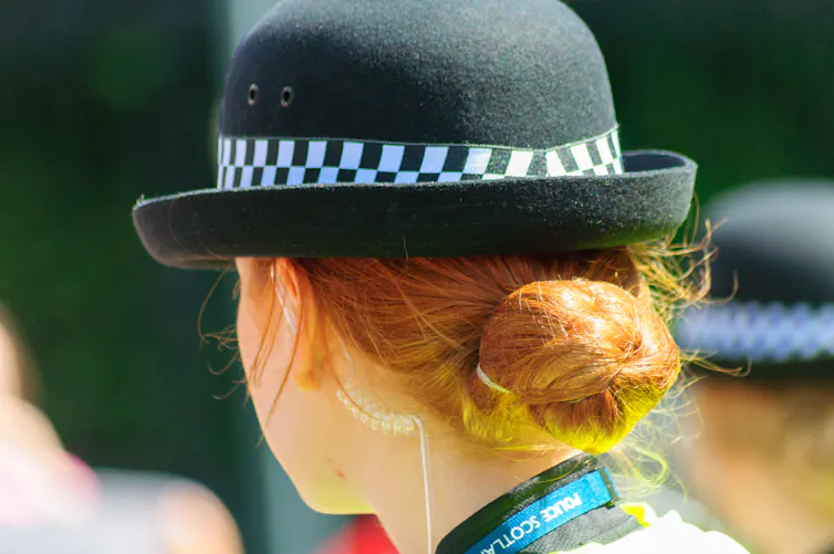 Closeup of the back of the head of a female police officer.
