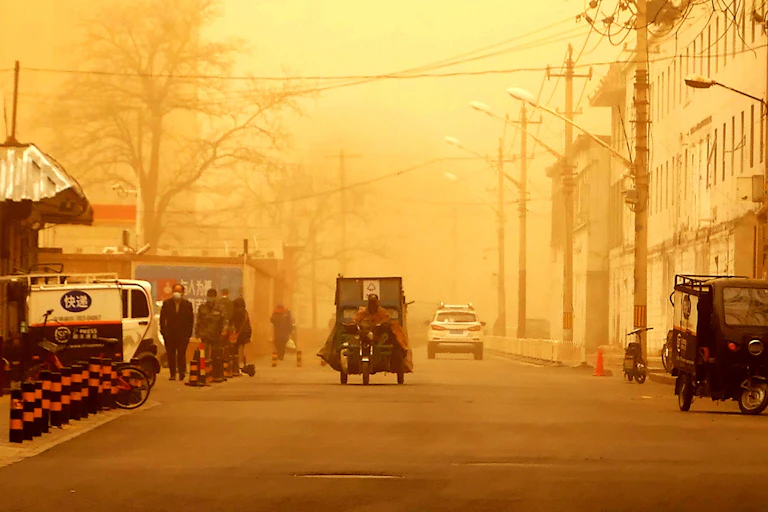 Rickshaw drives down street, everything shaded organge