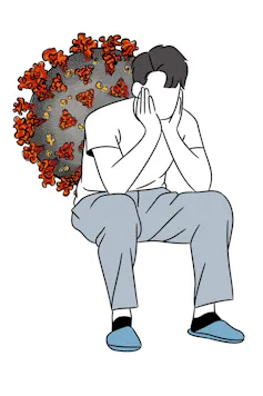 Young man sitting with his head in his hands