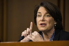 Sen. Amy Klobuchar speaks with her finger raised.