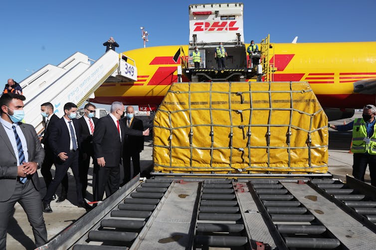 Israel's Prime Minister Benjamin Netanyahu attends the arrival of more than 100,000 doses Pfizer vaccines at Ben Gurion Airport on December 9 2020.