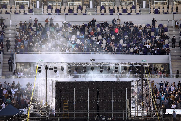 Israeli musician Ivri Lider performs at a football stadium in Tel Aviv on March 5 2021. Concert goers were required to show their 'green passport' to be be admitted, and also wear a mask.