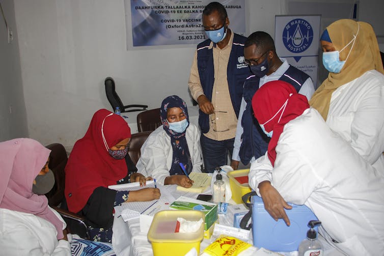 Medical staff gather around a table