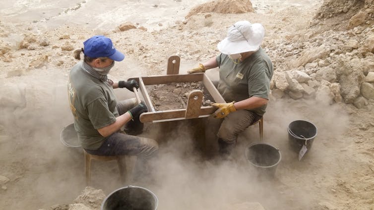 Archaeologists filtering debris