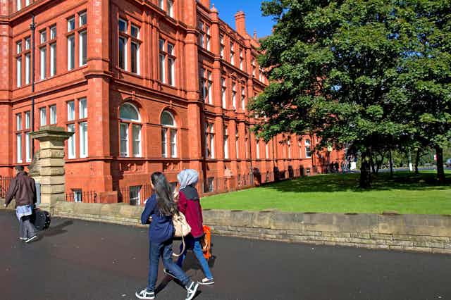 Students walking on the University of Salford's Peel Park Campus