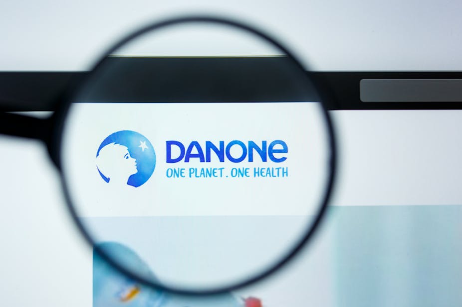 Danone logo under a magnifying glass