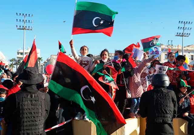 Libyans wave flags in a public square.