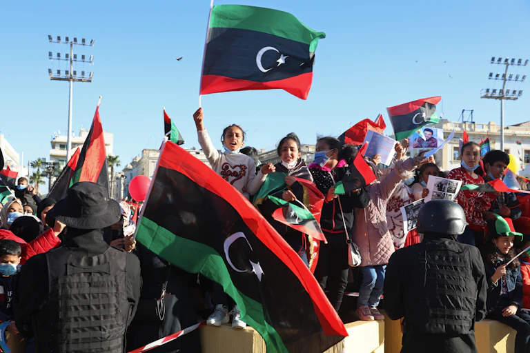 Libyans wave flags in a public square.