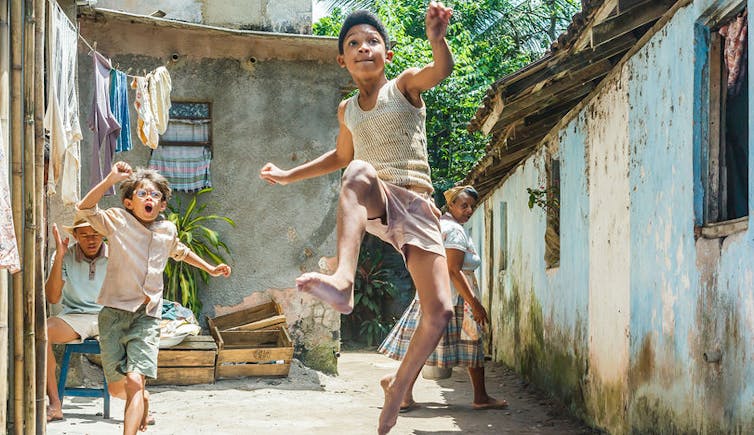 a young boy kicks his foot in the air