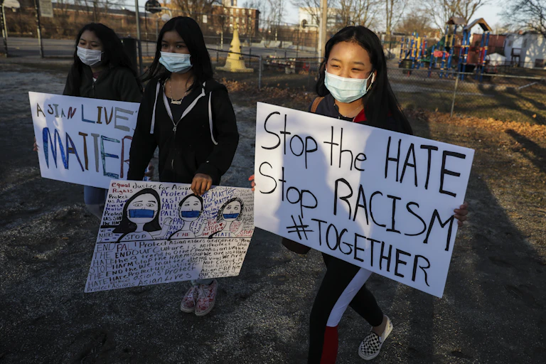 Children in a vigil holding signs that say "Asian Lives Matter" and "Stop the Hate"