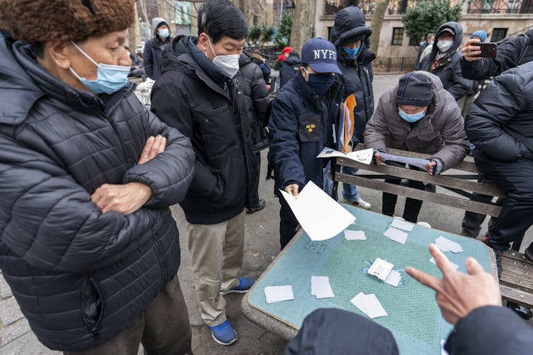 A detective in New York's Chinatown neighborhood handing out leaflets.