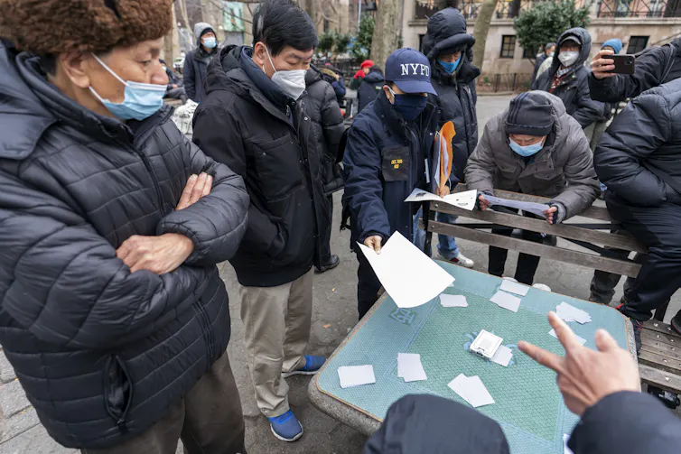 A detective in New York's Chinatown neighborhood handing out leaflets.