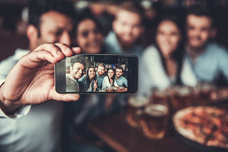 A group of five people taking a selfie.