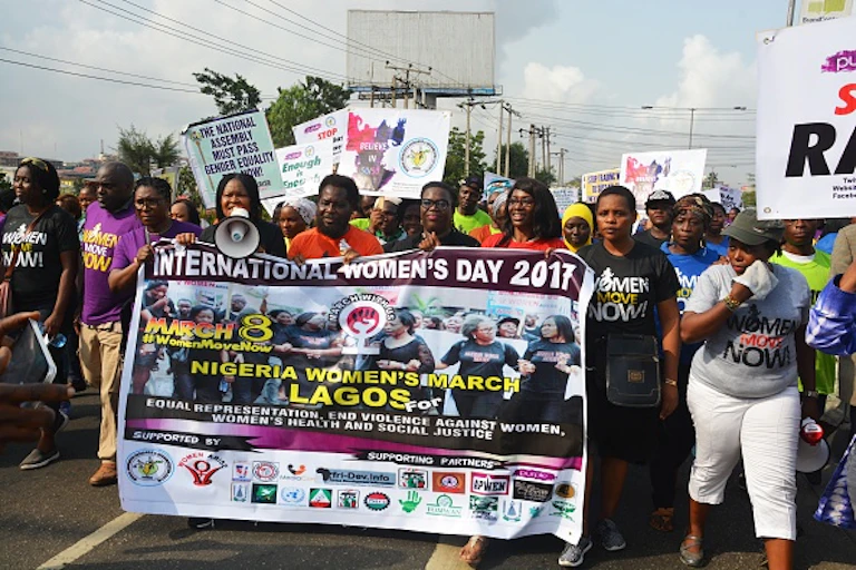 Women holding protest placards and banners.