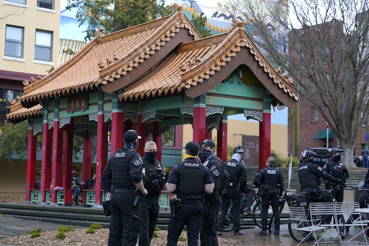 Police in a park in Seattle's Chinatown