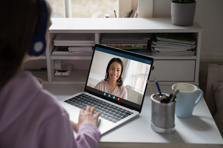 A woman attending a virtual class.
