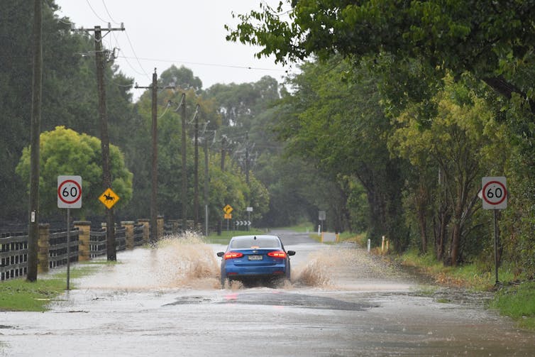 A car drives through flood waters