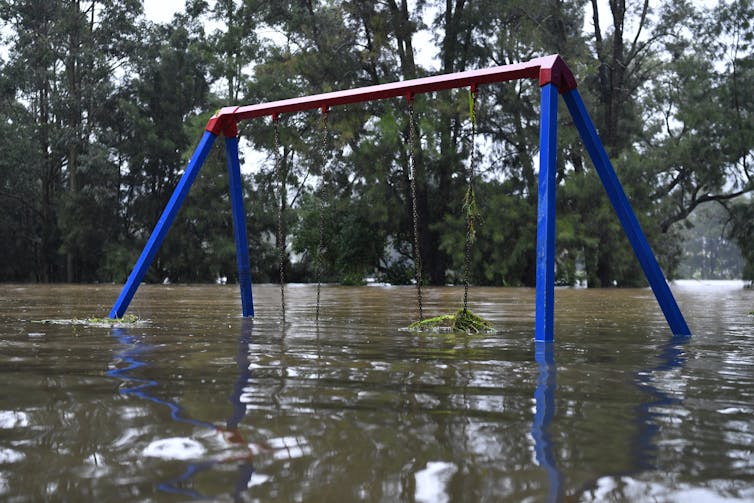 A playground is submerged in floodwaters.