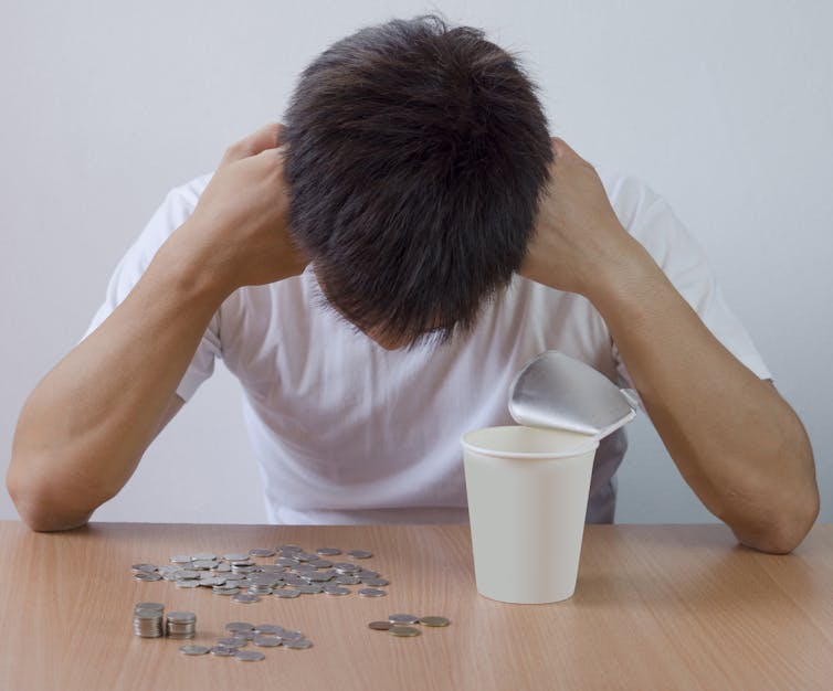 student with head in hands looks at how little money they have