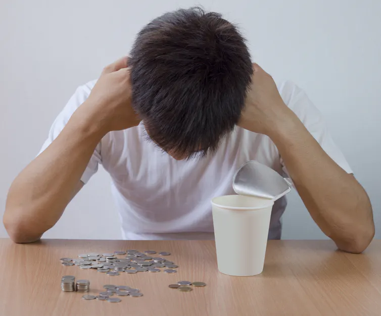 student with head in hands looks at how little money they have