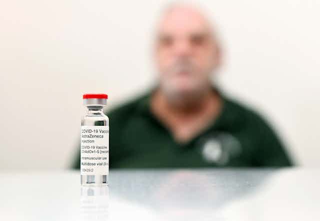 A vial of the AstraZeneca vaccine in front of a patient