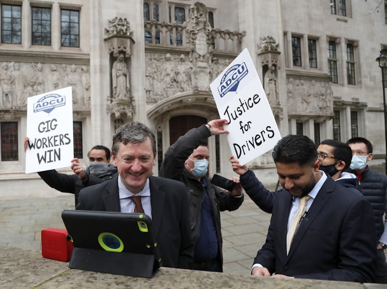 Former Uber drivers James Farrar and Yaseen Aslam celebrate the UK Supreme Court's decision on February 19 2021.