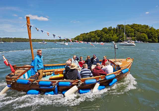 People in a boat on the River Dart.