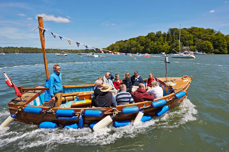 People in a boat on the River Dart.