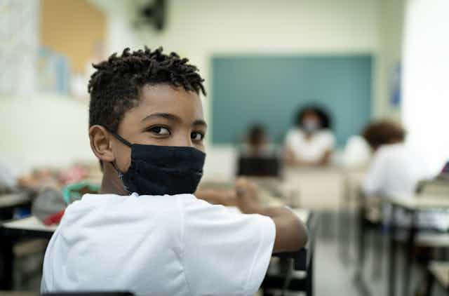Boy with mask in classroom