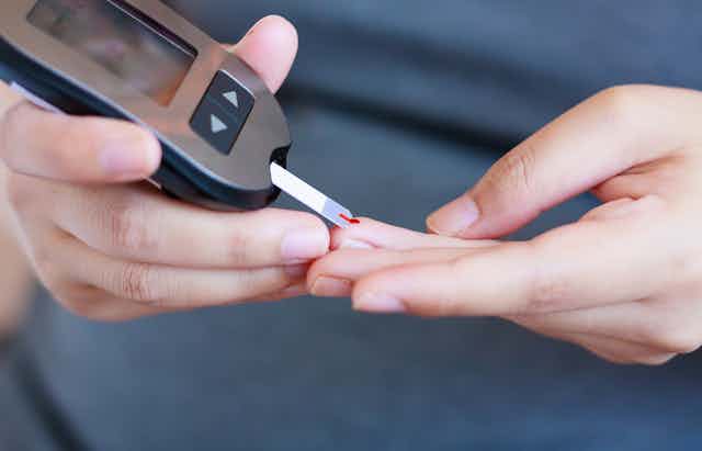 A blood glucose test being performed