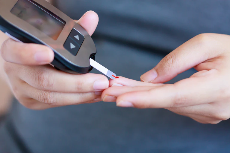 A blood glucose test being performed