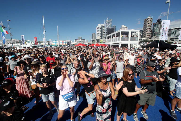 crowd of people with blue sky and city skyline