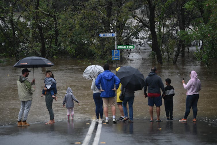 People watch swollen river