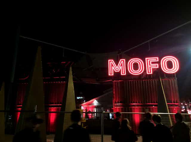 Neon red sign reading 'Mofo'