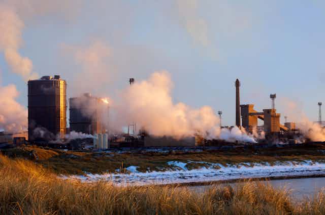An industrial scene on the coast during winter.