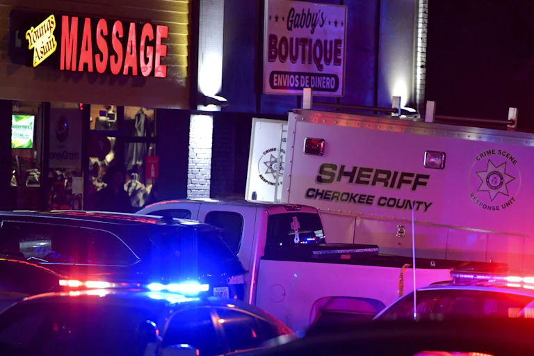 A police van sits outside an Atlanta-area massage parlor.