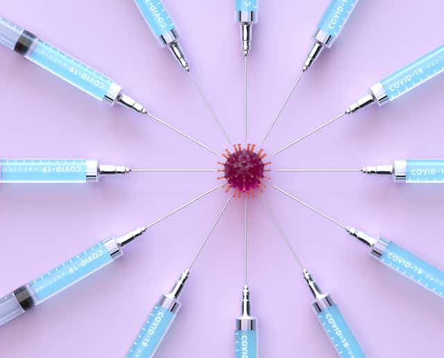 Multiple syringes sticking into a coronavirus particle